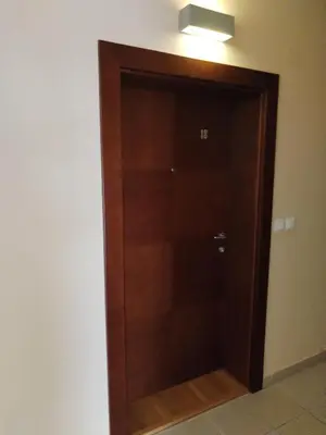 a wooden elevator door in a room at Apartman Besu in Vrnjačka Banja