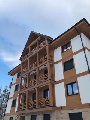 a tall building with a balcony on top of it at Nevena and Spa apartmans in Bukorovac