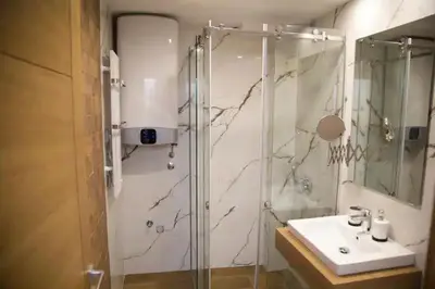 a bathroom with a shower and a sink at Nevena and Spa apartmans in Bukorovac