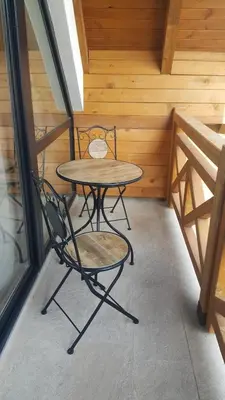 a table and two chairs sitting on a porch at Nevena and Spa apartmans in Bukorovac