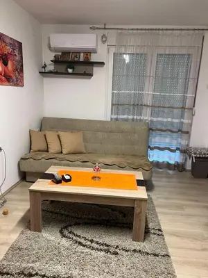 a living room with a couch and a coffee table at Stan u centru grada in Niš