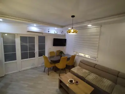 a living room with a couch and a table at Apartman Vulic Soko Banja in Soko Banja