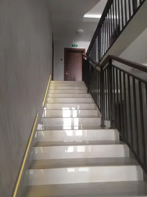 a stairway in a building with white stairs at Apartman Pogled Lux - Green Hill Sokobanja in Soko Banja