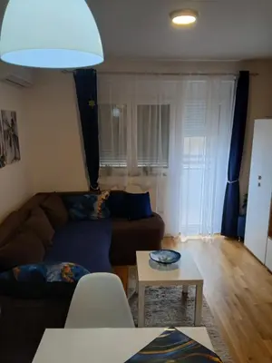 a living room with a couch and a table at Apartman Pogled Lux - Green Hill Sokobanja in Soko Banja