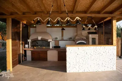 a kitchen with an outdoor kitchen with an oven at Vila Belgijska pruga in Zaječar