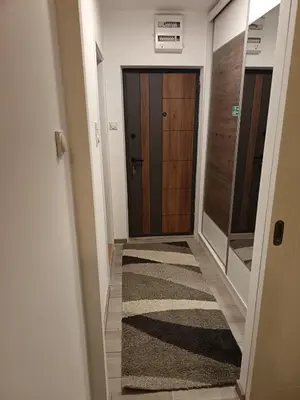 a hallway with a door and a rug at Omorika Brzeće in Brzeće