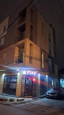 a building with a play sign in front of it at Play Apartments in Paraćin