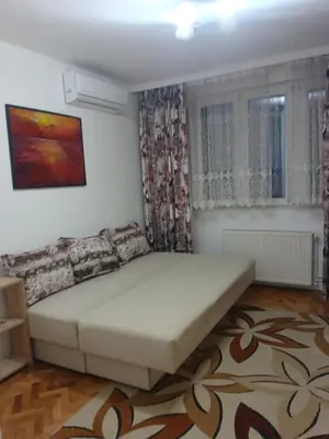 a bedroom with a large bed in a room at Stan in Niš