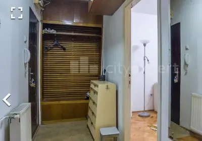 a room with a dresser and a closet with a window at Stan in Niš