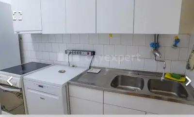 a kitchen with a sink and a counter top at Stan in Niš