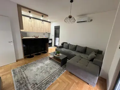 a living room with a couch and a table at Mija in Vrnjačka Banja
