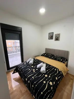 a bedroom with a bed with towels on it at Mija in Vrnjačka Banja