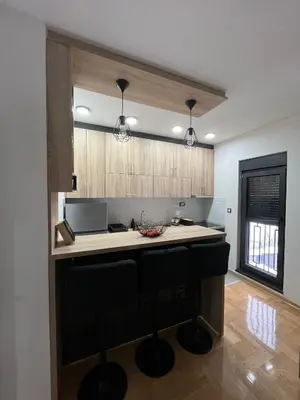 a kitchen with a island in the middle of a room at Mija in Vrnjačka Banja