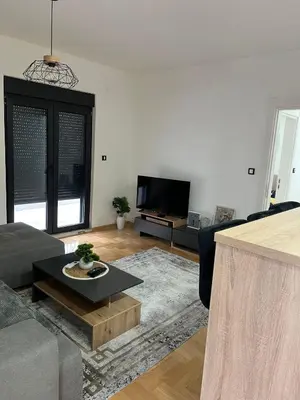 a living room with a couch and a table at Mija in Vrnjačka Banja