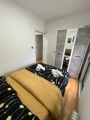 a bedroom with a bed and a large mirror at Mija in Vrnjačka Banja