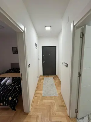 a bedroom with a bed and a hallway with a door at Mija in Vrnjačka Banja