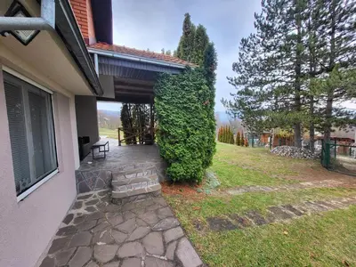 a porch of a house with a bench in the yard at Vila Dolina Mira pored Jerme in Gradište