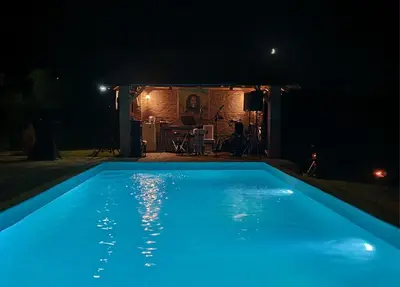 a swimming pool at night with blue illumination at Vila Dolina Mira pored Jerme in Gradište