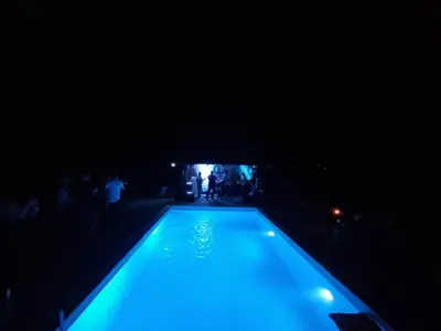 a swimming pool at night with blue lights at Vila Dolina Mira pored Jerme in Gradište