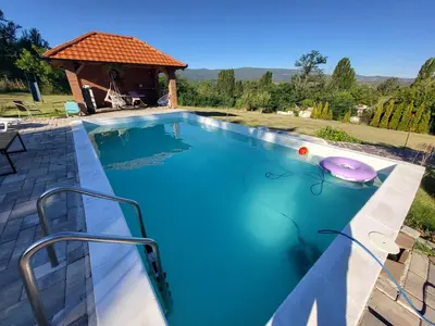 a large swimming pool with a gazebo at Vila Dolina Mira pored Jerme in Gradište