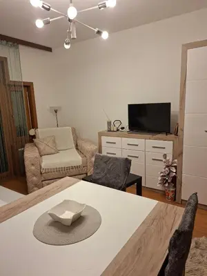 a living room with a table with a hat on it at apartman Nevena in Vrnjačka Banja