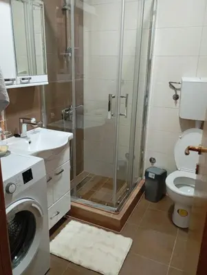 a bathroom with a shower and a toilet and a sink at apartman Nevena in Vrnjačka Banja