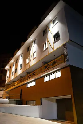 a building with lights on the side of it at Sonja apartman Vila Bela reka Brzeće Kopaonik in Brzeće