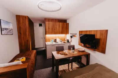 a small living room with a couch and a table at Sonja apartman Vila Bela reka Brzeće Kopaonik in Brzeće
