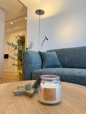 a living room with a table with a jar of candy canes at Nordic City View Apartment in Niš