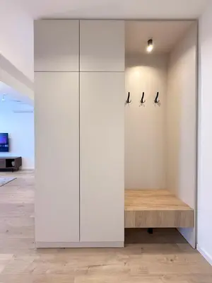 a large white closet with three birds on the wall at Nordic City View Apartment in Niš