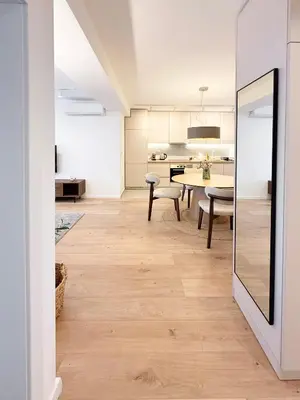 a kitchen and dining room with a table and chairs at Nordic City View Apartment in Niš