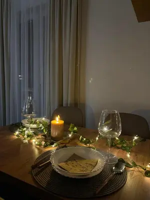 a table with a candle and a plate with a candle at Apartman Brankovic in Jagodina