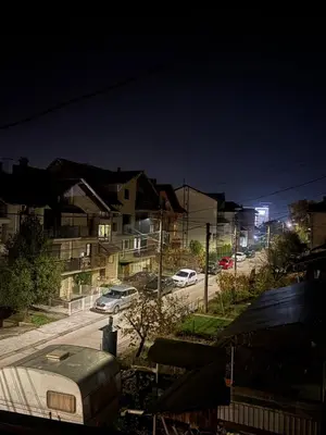 a view of a street at night with cars parked at Apartman Brankovic in Jagodina