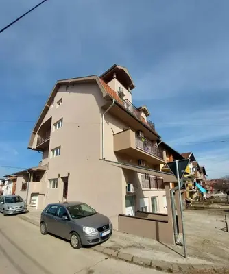 a building with a car parked in front of it at Apartman Brankovic in Jagodina