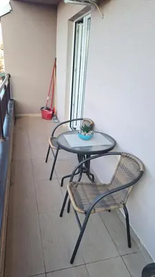 a glass table and a chair in a room at Apartman Brankovic in Jagodina
