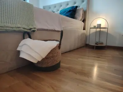 a living room with a couch and a basket of towels at Harmony Dream in Jagodina