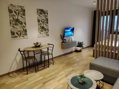 a living room with a couch and a table and chairs at Harmony Dream in Jagodina