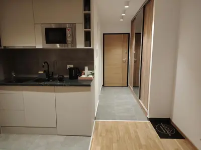 a kitchen with white cabinets and a counter top at Harmony Dream in Jagodina