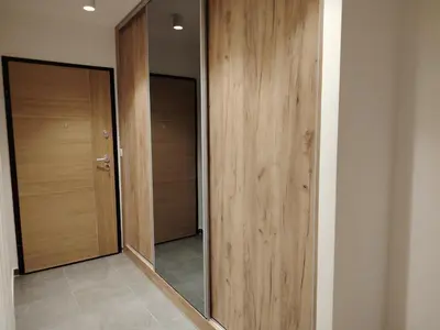 a hallway with two wooden doors and a mirror at Harmony Dream in Jagodina