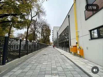 a person walking down a sidewalk next to a building at Harmony Dream in Jagodina