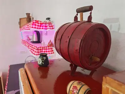 a red barrel sitting on top of a table at Apartmani Deda Zarkova Vodenica in Ćuštica