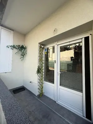 a front door of a house with a window at Apartman Petra Sokobanja in Soko Banja