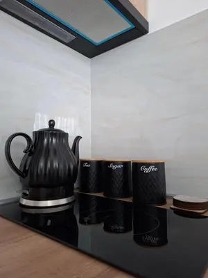 a black coffee pot sitting on a counter with mugs at Vikvid in Kopaonik