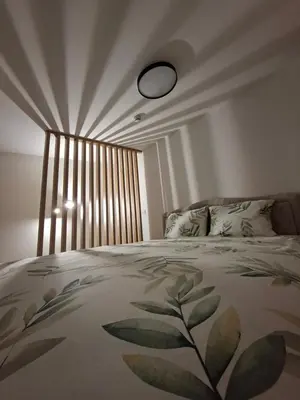 a bedroom with a bed with a large window at Vikvid in Kopaonik