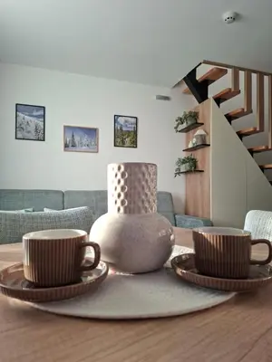 two coffee cups on a table in a living room at Vikvid in Kopaonik