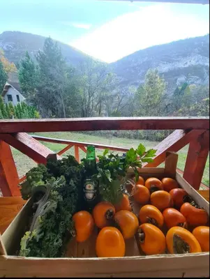 a box of fruit and vegetables on a table at Vila Nina - gde duša diše in Niška Banja