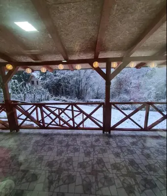 a room with a wooden fence and snow covered trees at Vila Nina - gde duša diše in Niška Banja