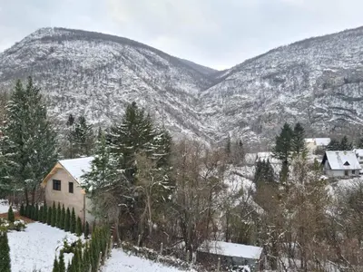 a house in the snow in front of a mountain at Vila Nina - gde duša diše in Niška Banja