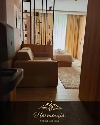 a living room with a couch and a table at Harmonija Residence Hill 01 in Kopaonik