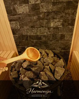 a wooden spoon sitting on a bowl of rocks at Harmonija Residence Hill 01 in Kopaonik